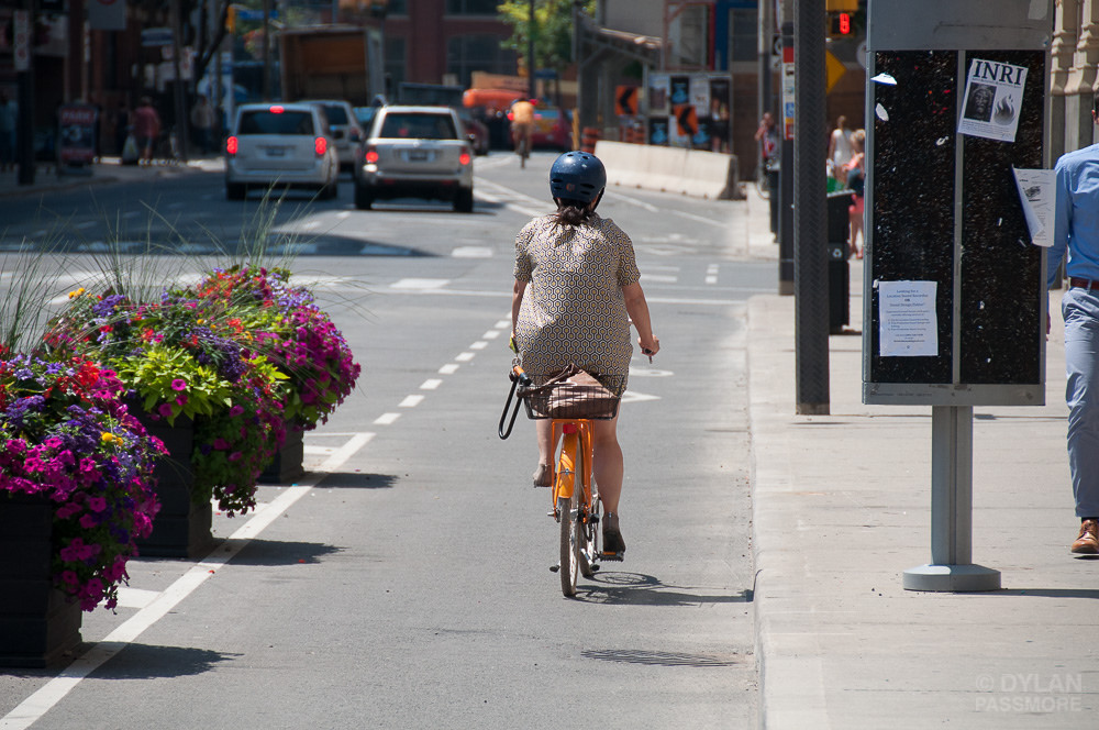 Woman cycling on Richmond protected bike lane (Photo credit: Dylan Passmore)
