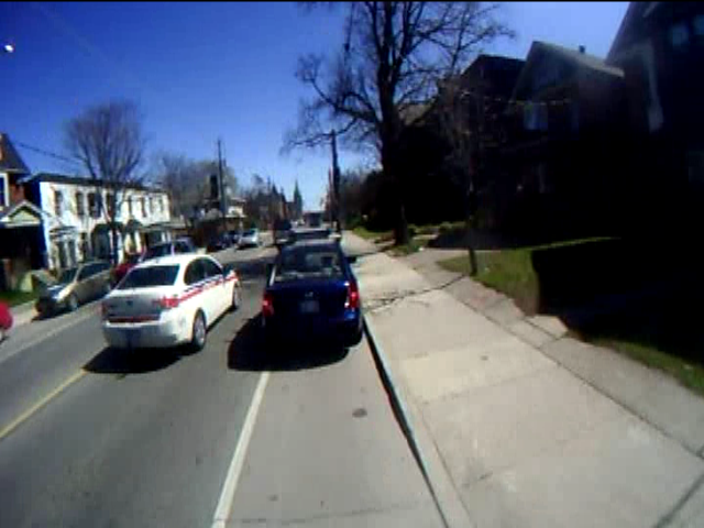Police car passing an illegally stopped car Police car passing an illegally stopped car