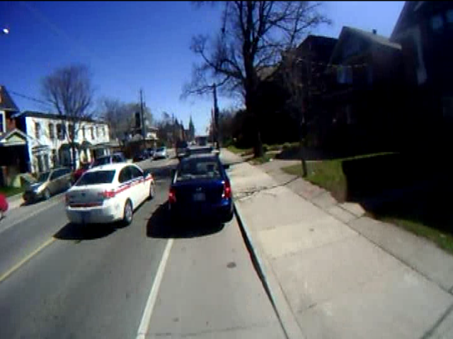 Police car passing an illegally stopped car